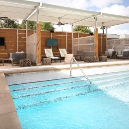 swimming pool with lounge chairs around it