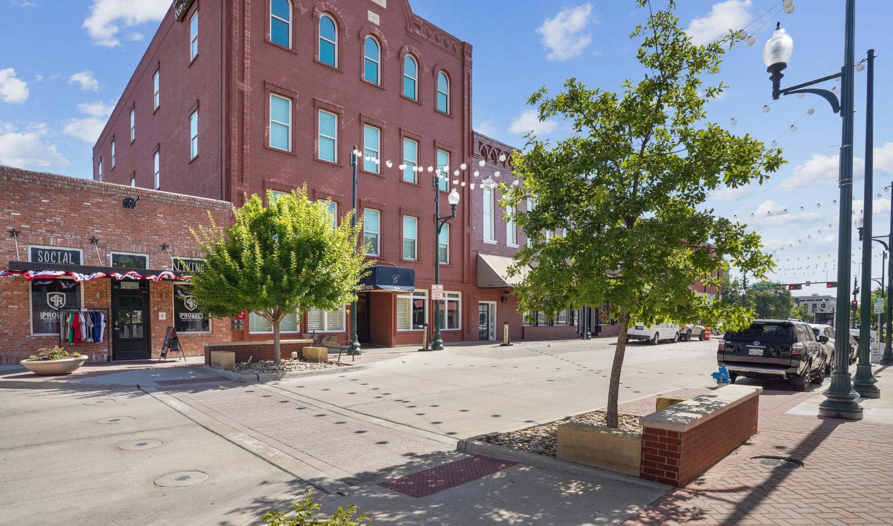 The essence of exceptional living a street with a brick building and a tree