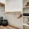 a closet with a white shelf with objects on it