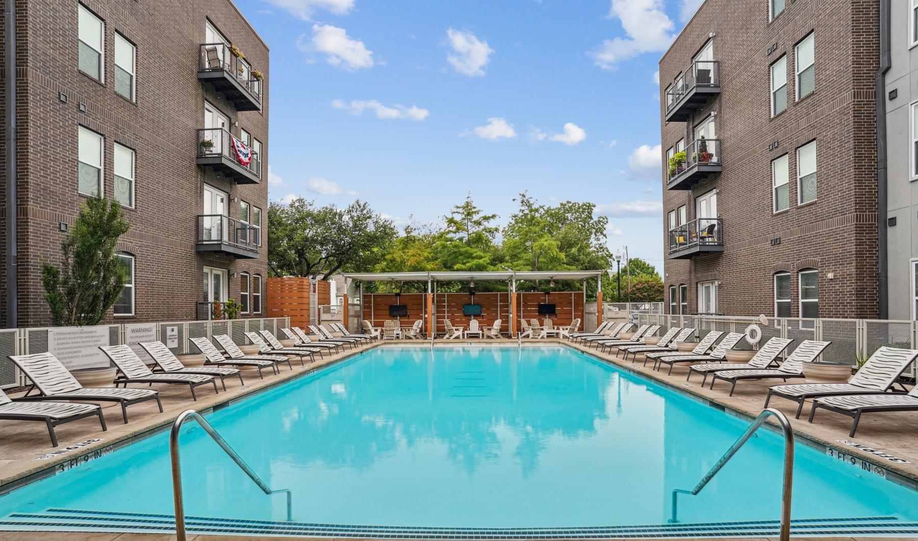 Relax and unwind poolside a swimming pool in a courtyard