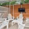 a patio with a table and chairs