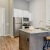 a kitchen with a bar stool and a table