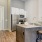 a kitchen with a bar stool and a table