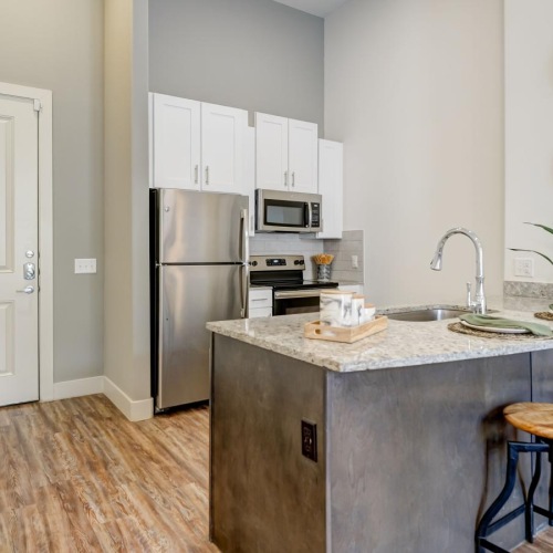 Beautiful kitchens with designer finishes a kitchen with a bar stool and a table